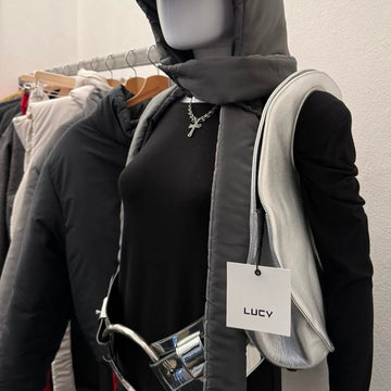 LUCY bag hanging on clothing rack with branded LUCY tag, Stranger Studio showroom Florence